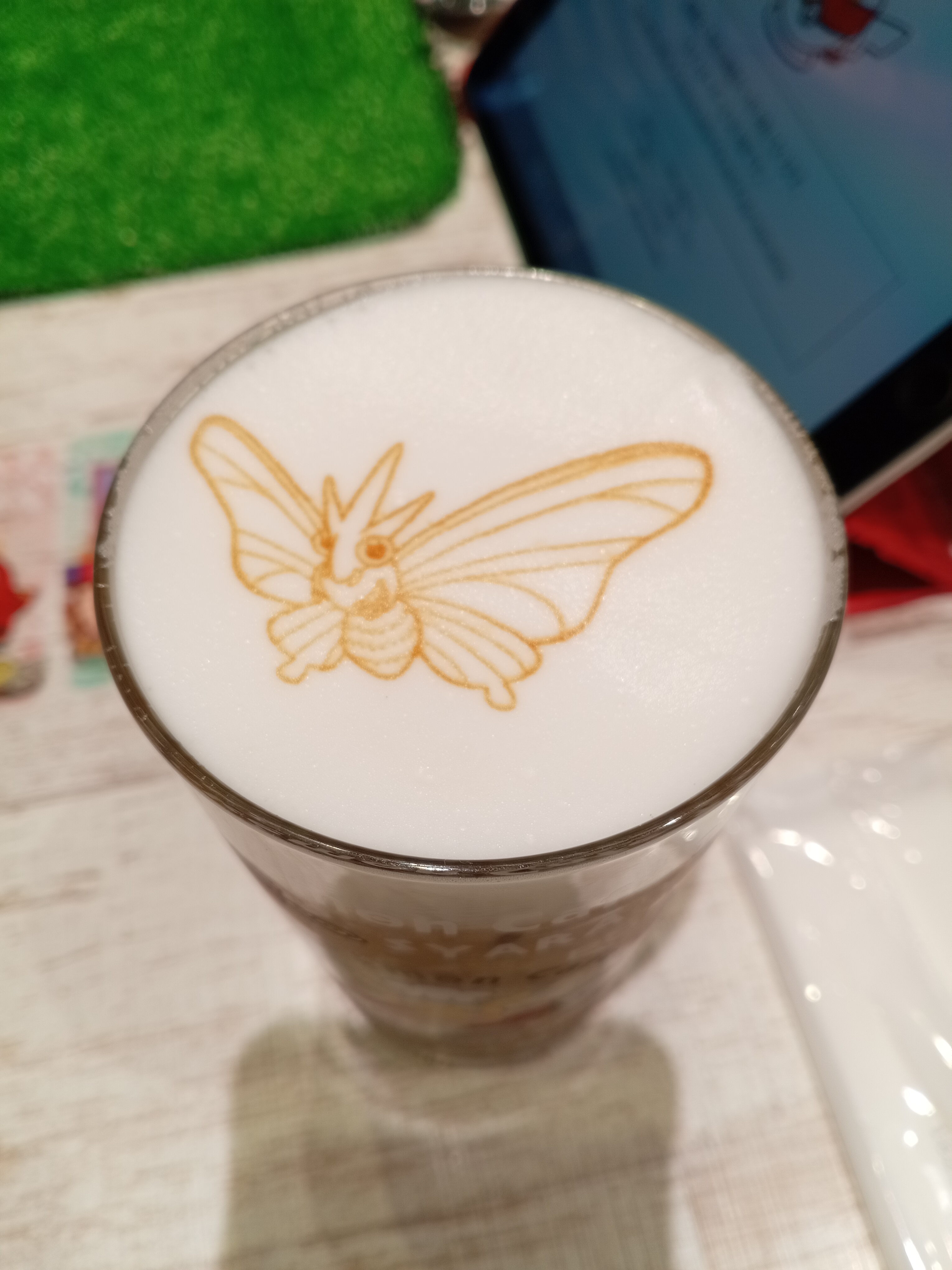 photo of pokémon café's iced mocha, with a venomoth printed on top